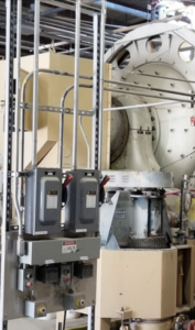 A ball mill and its control equipment inside the facility.