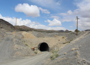 A mine portal set into a rocky hillside.