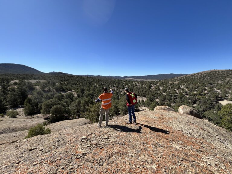 A wide view of two geologists looking across the hills towards Goldwedge.